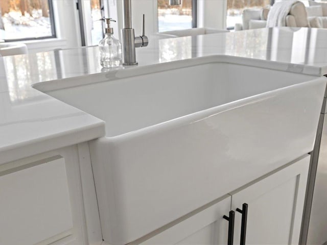 room details featuring white cabinetry and a sink