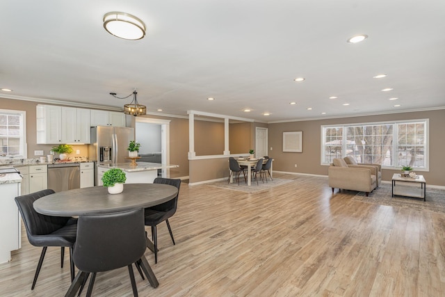 dining room featuring recessed lighting, baseboards, light wood-style floors, and crown molding