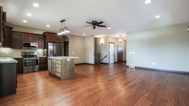 kitchen featuring visible vents, dark brown cabinets, appliances with stainless steel finishes, and light countertops