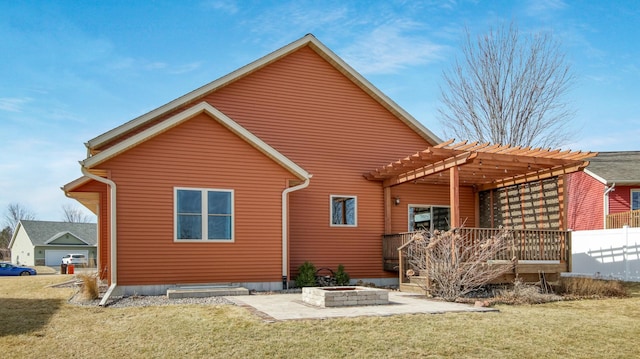 back of house featuring a lawn, a pergola, and a patio