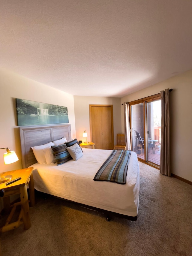 carpeted bedroom with access to outside, baseboards, and a textured ceiling