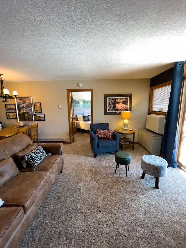 living room with a notable chandelier, baseboard heating, carpet flooring, and a textured ceiling