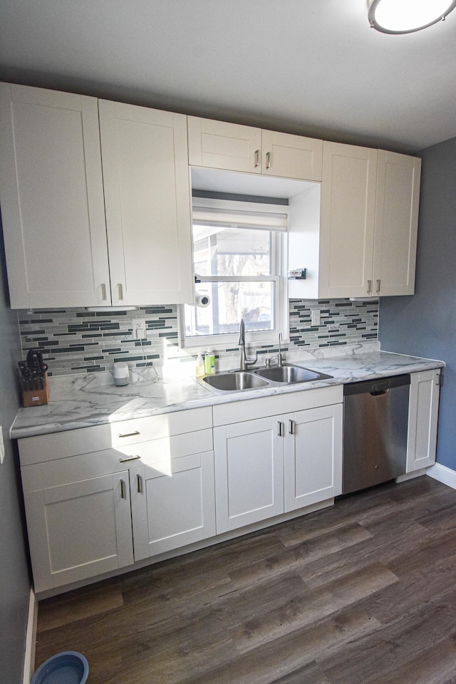 kitchen with dishwasher, light countertops, decorative backsplash, dark wood-style floors, and a sink