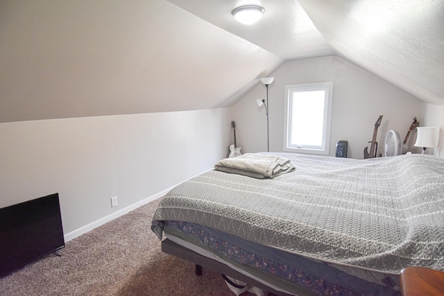 bedroom with lofted ceiling, baseboards, and carpet floors