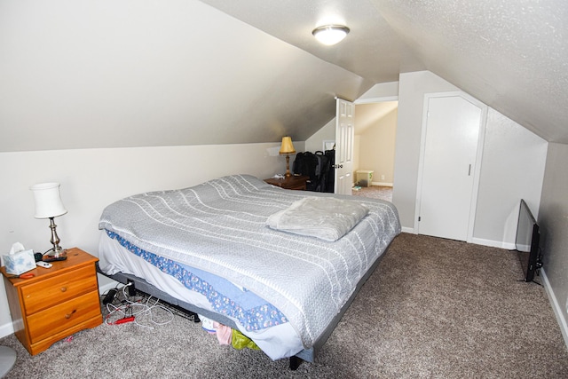 carpeted bedroom featuring lofted ceiling, baseboards, and a textured ceiling