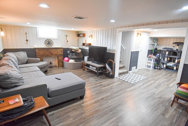 living area with visible vents, recessed lighting, stairway, and wood finished floors