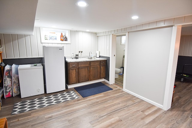 bathroom with recessed lighting, toilet, vanity, and wood finished floors