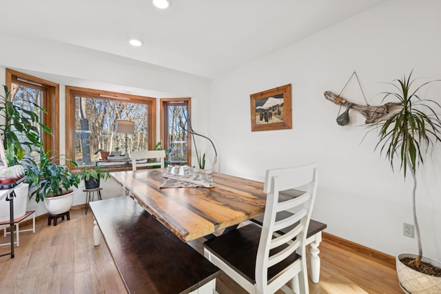 dining room featuring light wood-style flooring, recessed lighting, and baseboards