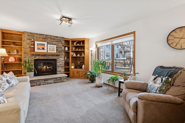 carpeted living area with a fireplace and built in shelves