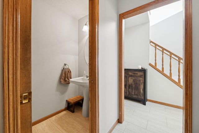 bathroom with baseboards and a sink