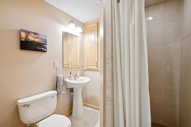 bathroom featuring tile patterned floors, toilet, a stall shower, and a textured ceiling