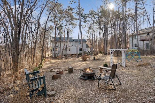 view of yard with a fire pit