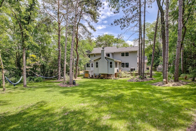 rear view of property featuring a lawn