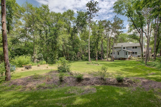 view of yard with an outdoor fire pit