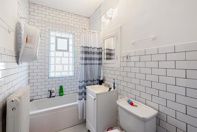 bathroom featuring tile walls, toilet, shower / tub combo with curtain, radiator heating unit, and vanity