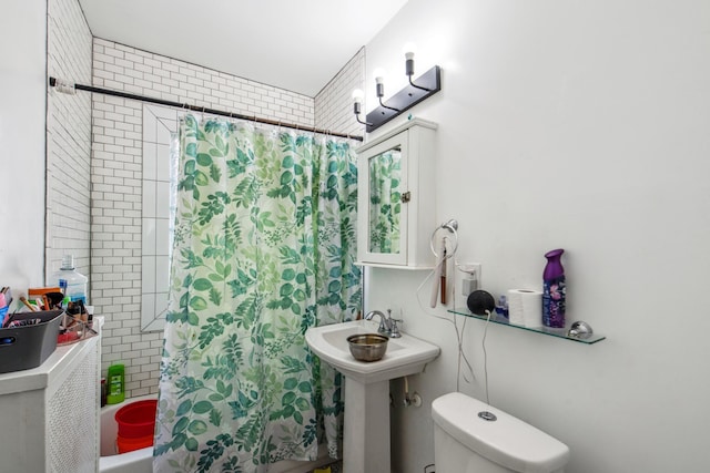 full bathroom with shower / bath combination with curtain, toilet, and a sink