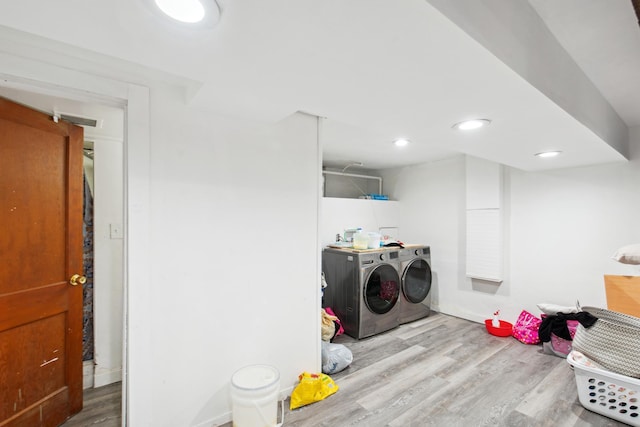 laundry area featuring laundry area, recessed lighting, wood finished floors, and washing machine and clothes dryer