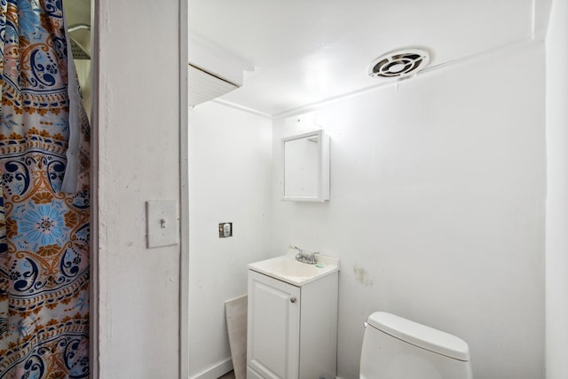 full bath featuring vanity, toilet, and visible vents