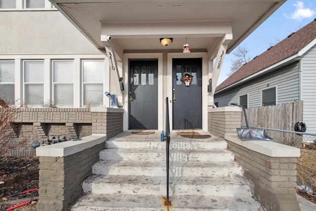 doorway to property featuring fence