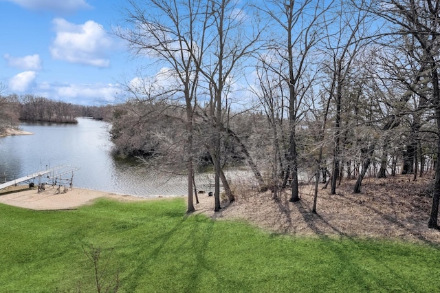 view of yard featuring a boat dock and a water view