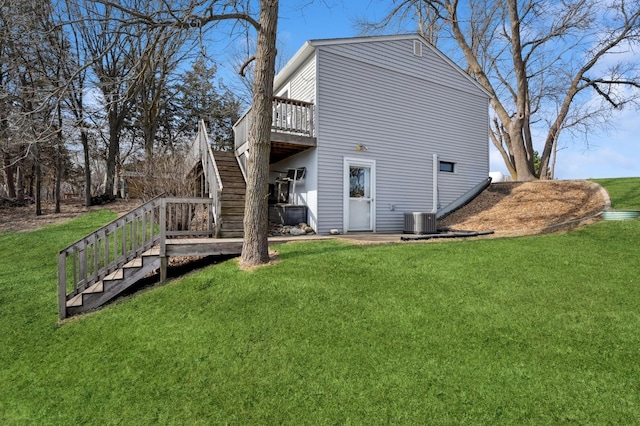 rear view of house with a wooden deck, stairs, a yard, and cooling unit