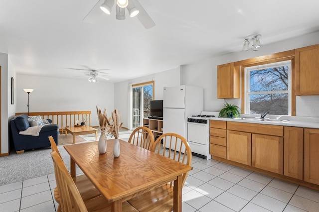 dining area with a ceiling fan and light tile patterned floors