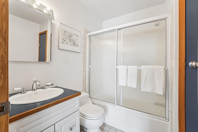 full bath with vanity, bath / shower combo with glass door, and toilet