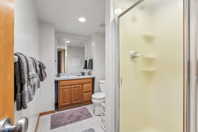 bathroom featuring toilet, a shower stall, tile patterned flooring, and vanity