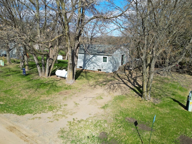 view of yard with dirt driveway