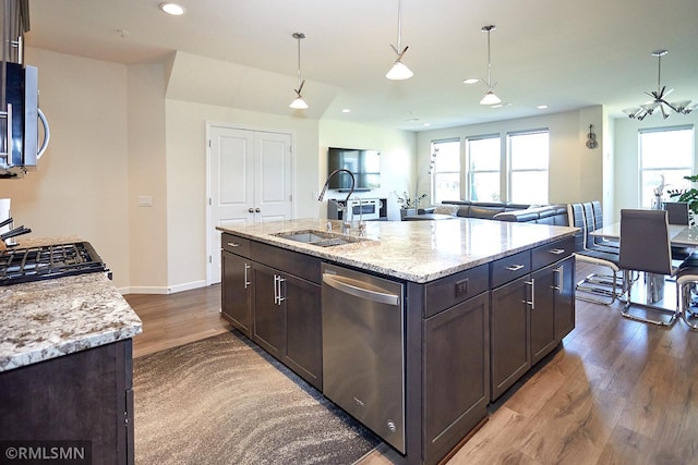 kitchen with recessed lighting, dark wood-style flooring, a sink, stainless steel appliances, and dark brown cabinets