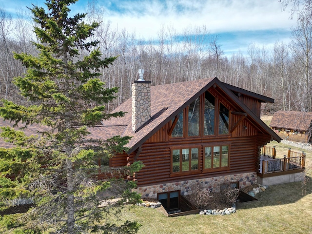19605 Jigsaw Dr, Park Rapids, MN 56470 - rear view of house with log exterior, a chimney, a shingled roof, and a lawn