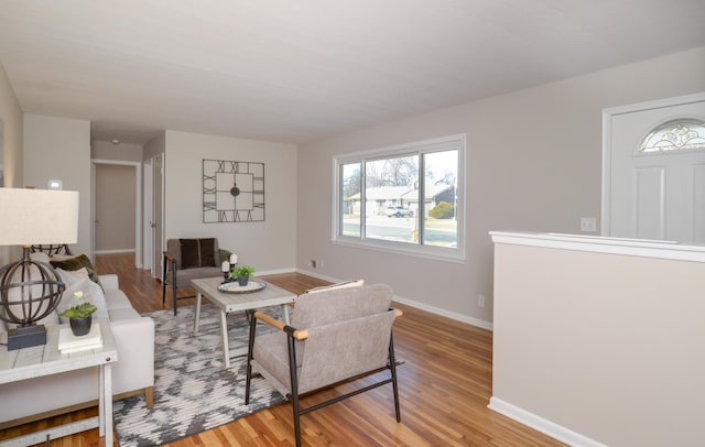 living room featuring baseboards and wood finished floors