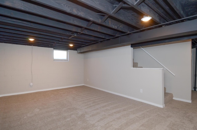 basement featuring stairway and carpet floors