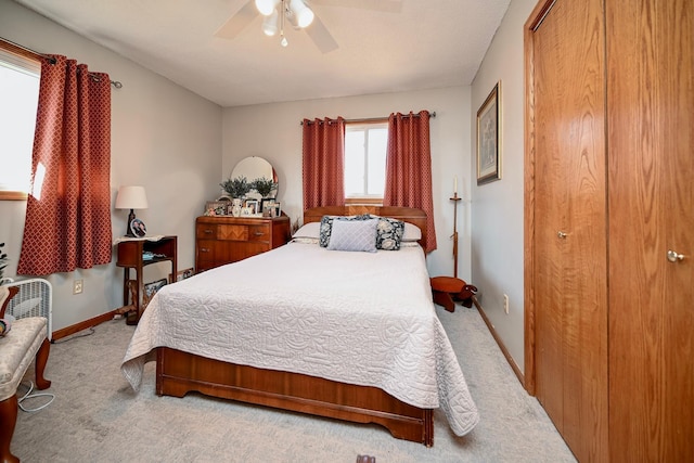 carpeted bedroom with baseboards and ceiling fan