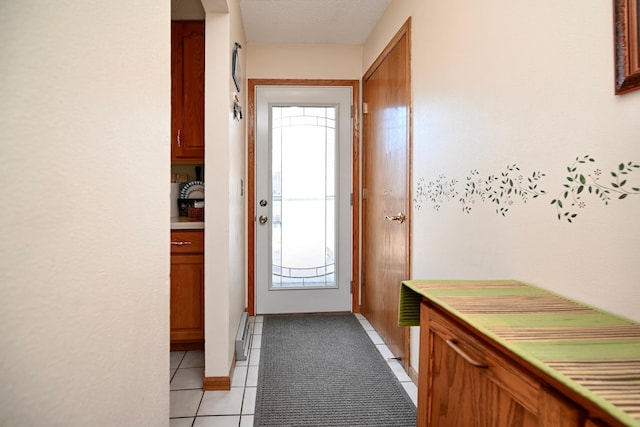 entryway with light tile patterned floors