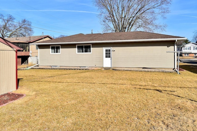 rear view of property featuring a yard