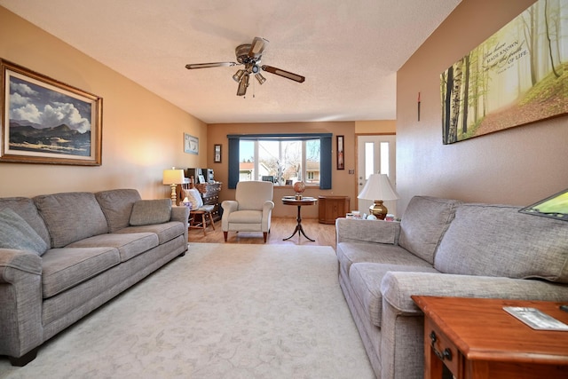 living area featuring a textured ceiling and a ceiling fan