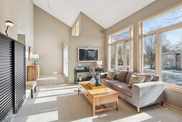 living room with visible vents, baseboards, carpet, and high vaulted ceiling