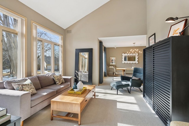 living room featuring a notable chandelier, high vaulted ceiling, and carpet