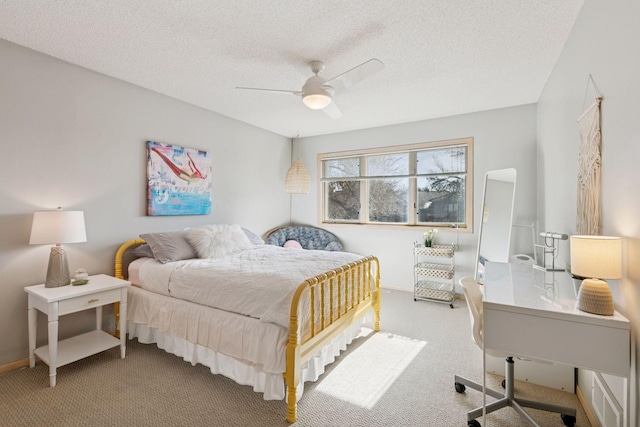 carpeted bedroom with baseboards, a textured ceiling, and ceiling fan