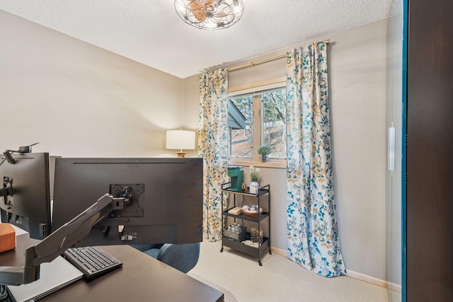 home office featuring baseboards, a textured ceiling, and carpet