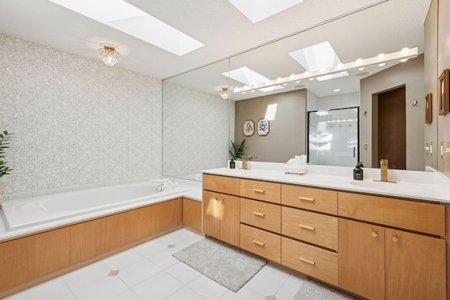 full bathroom featuring vanity, a skylight, tile patterned flooring, a shower stall, and a bath