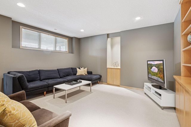 living area with recessed lighting, light colored carpet, and a textured ceiling