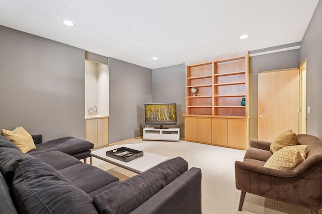 living room featuring recessed lighting, carpet, baseboards, and a textured ceiling