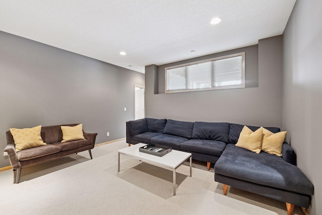 living area with recessed lighting, light colored carpet, a textured ceiling, and baseboards