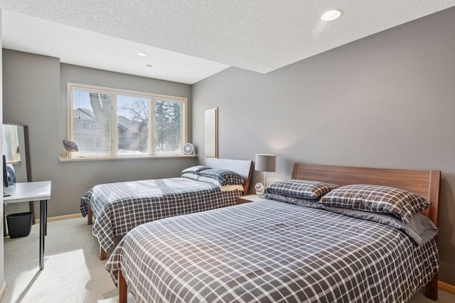 bedroom featuring a textured ceiling, baseboards, and carpet floors