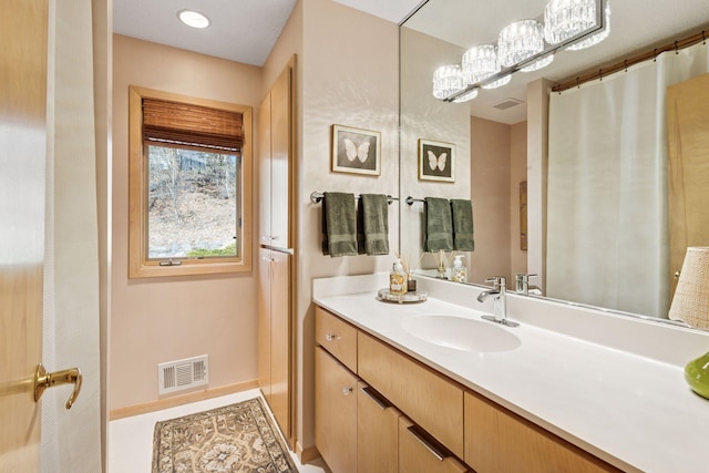 bathroom with visible vents, baseboards, and vanity