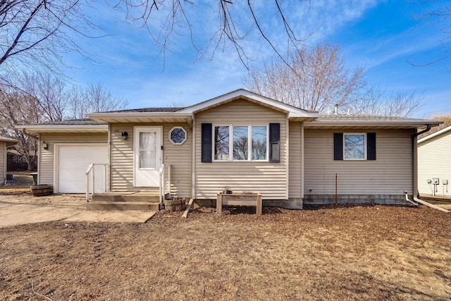 single story home with driveway and a garage