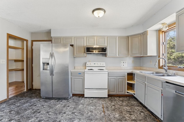 kitchen featuring gray cabinetry, a sink, light countertops, appliances with stainless steel finishes, and a textured ceiling