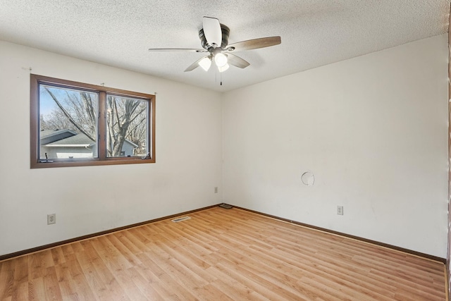 unfurnished room with visible vents, baseboards, a textured ceiling, and light wood finished floors